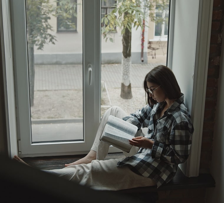 girl reading at tilt and turn european windows